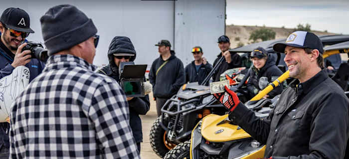 Travis Pastrana (right) puts his money where his mouth is at -- even if it's just a simple dollar bill -- and Brian Deegan (left) says "You're on, that's a bet." Photo: Long Nguyen.